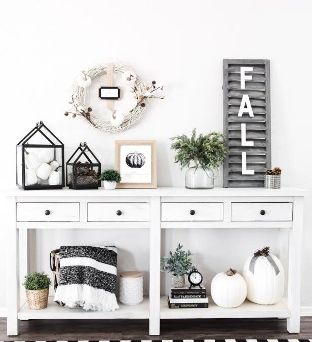 White console table decorated for fall