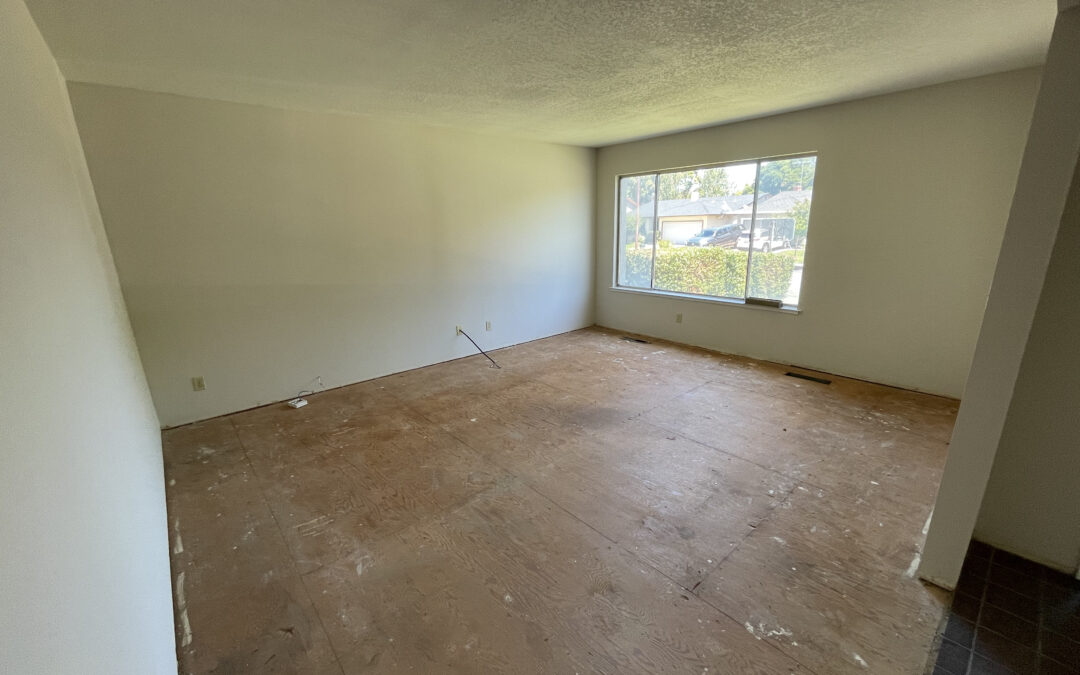 Empty living room with bare subfloor and window